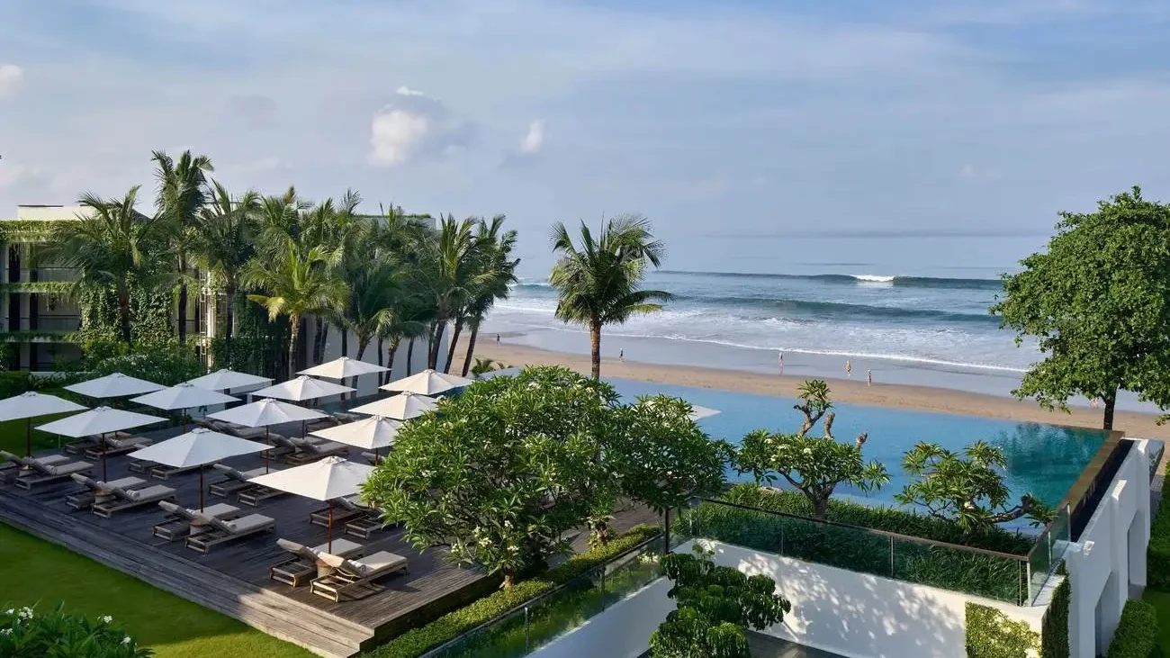 An aerial view of Alila Seminyak, showing its vertical gardens, pool deck, and direct beach access