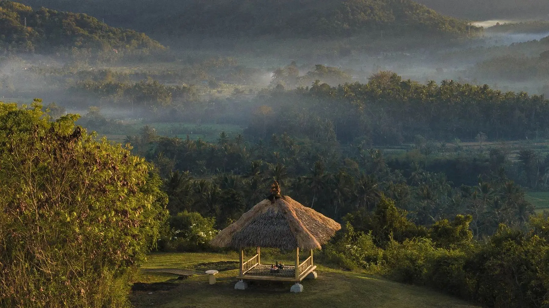 A gazebo in the mist at Amankila, architecture set low into its own landscape