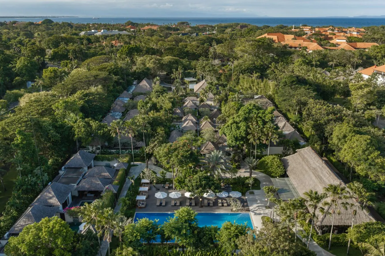 Amarterra from the air, its thatched villas among the trees of the Nusa Dua enclave with the sea beyond
