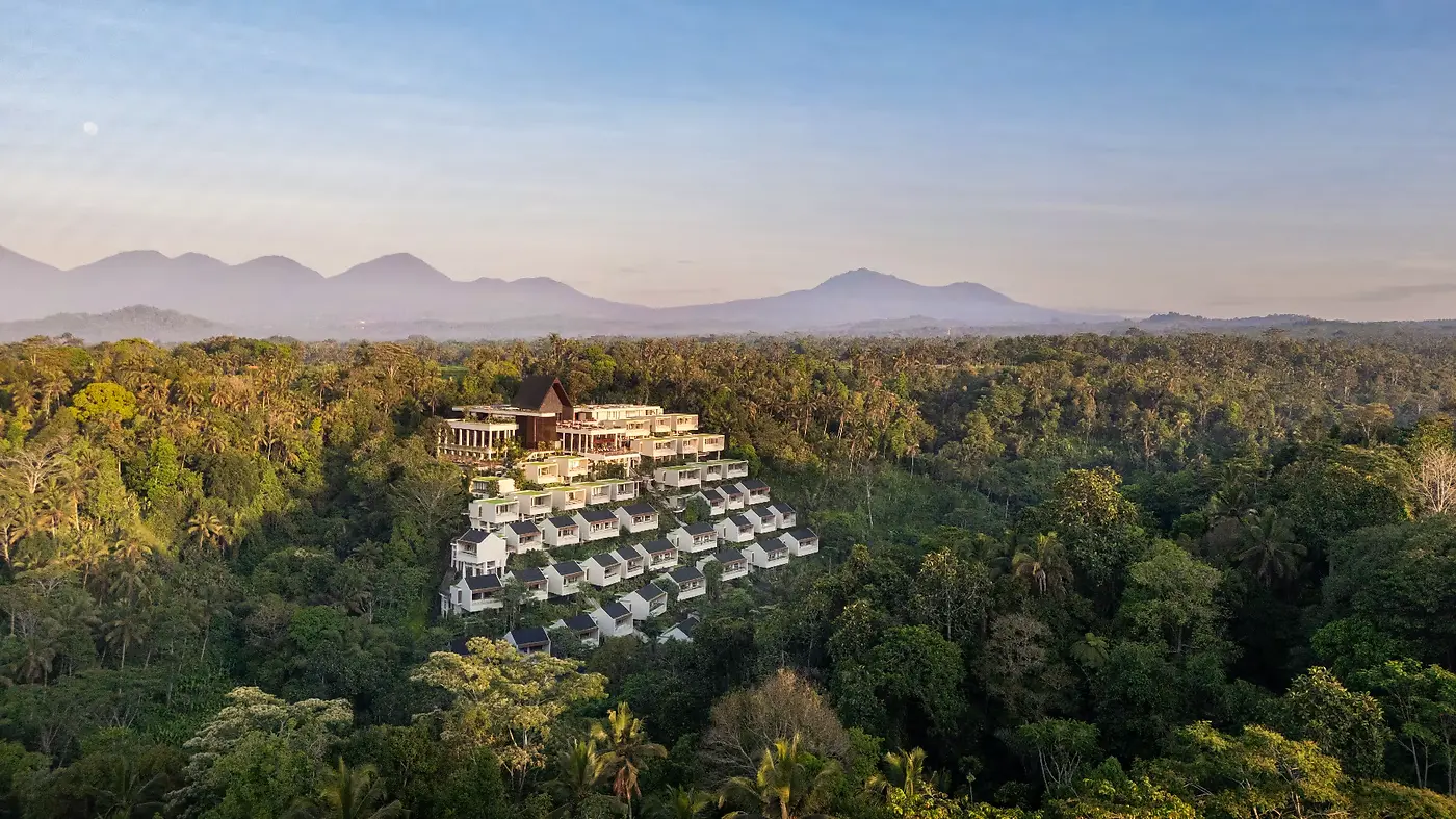 Aerial view of Anantara Ubud's terraces stepping down the forested hillside, connected by a funicular
