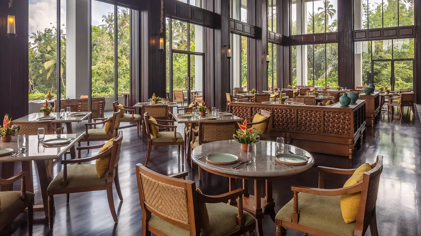 Kirana restaurant at Anantara Ubud, floor-to-ceiling glass walls looking onto the rainforest