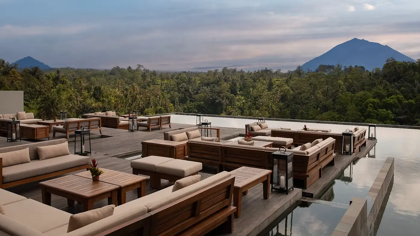 The Lobby Lounge at Anantara Ubud at dusk, an open-air roof deck looking towards two mountain peaks