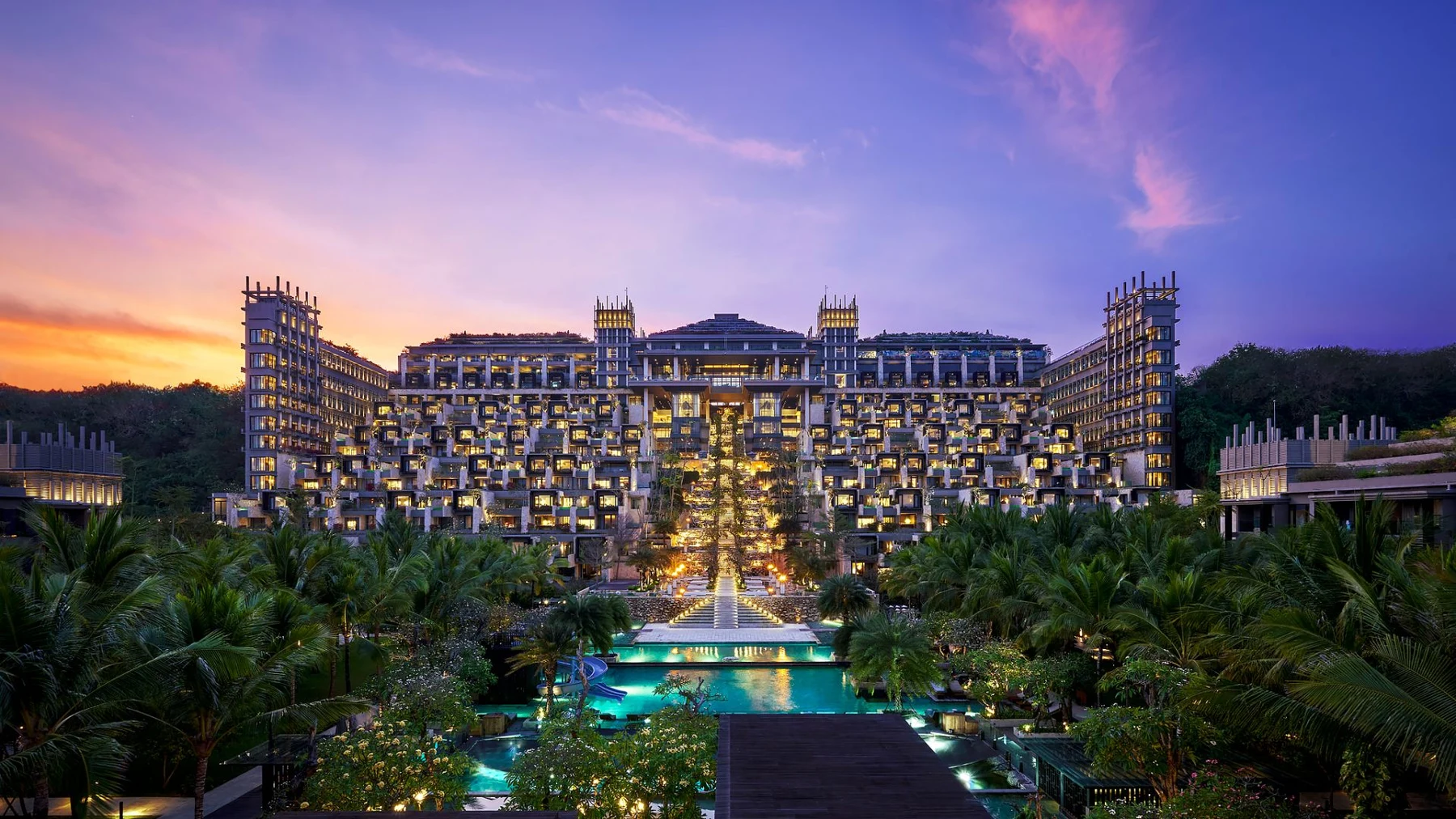 The Apurva Kempinski Bali at dusk, the Grand Staircase and pools cascading through the centre of the resort
