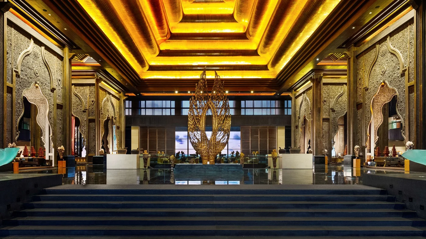 The Pendopo lobby at The Apurva Kempinski Bali, gold ceiling and a sculptural centrepiece rising above the entrance stairs