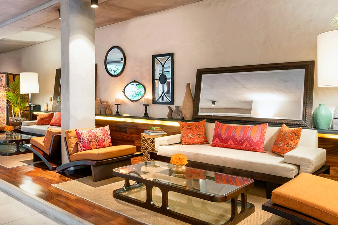 The lounge at Bisma Eight, low seating and ikat cushions against raw concrete