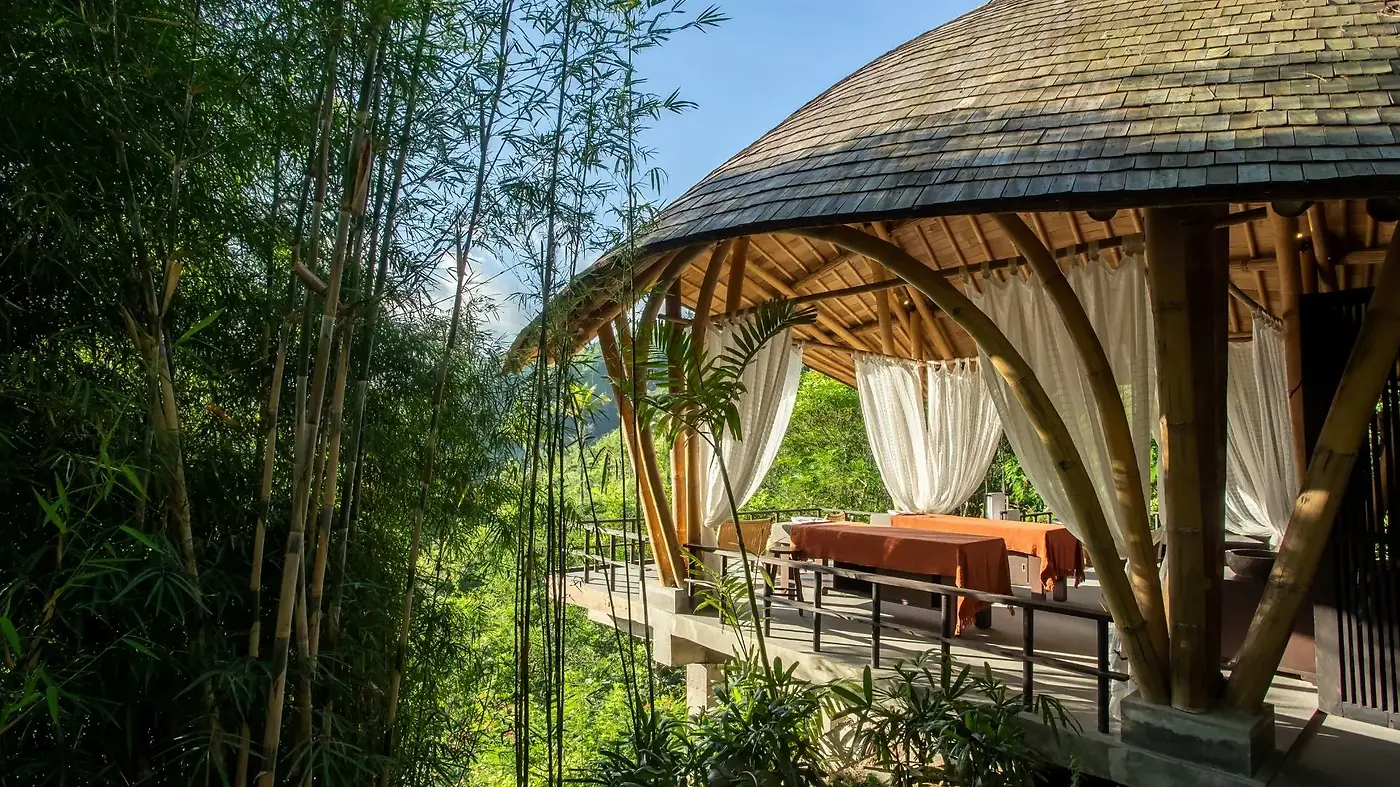 An open-air bamboo spa pavilion at Buahan, set among bamboo groves above the valley