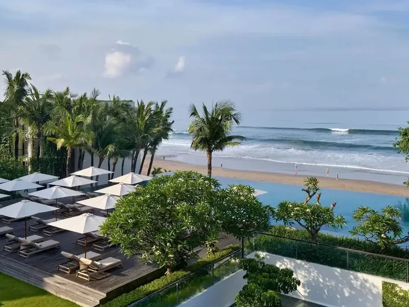 An aerial view of Alila Seminyak, showing its vertical gardens, pool deck, and direct beach access