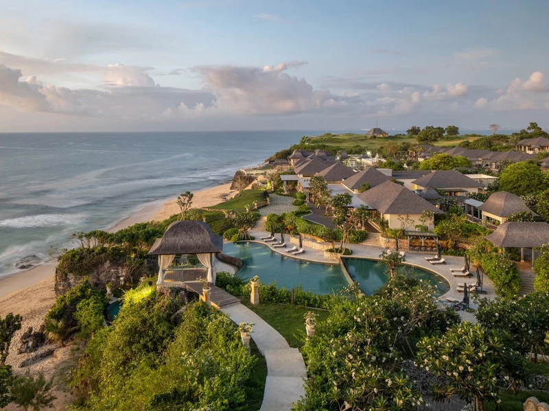 Jumeirah Bali's Majapahit water palace and pools above Dreamland Beach at dusk