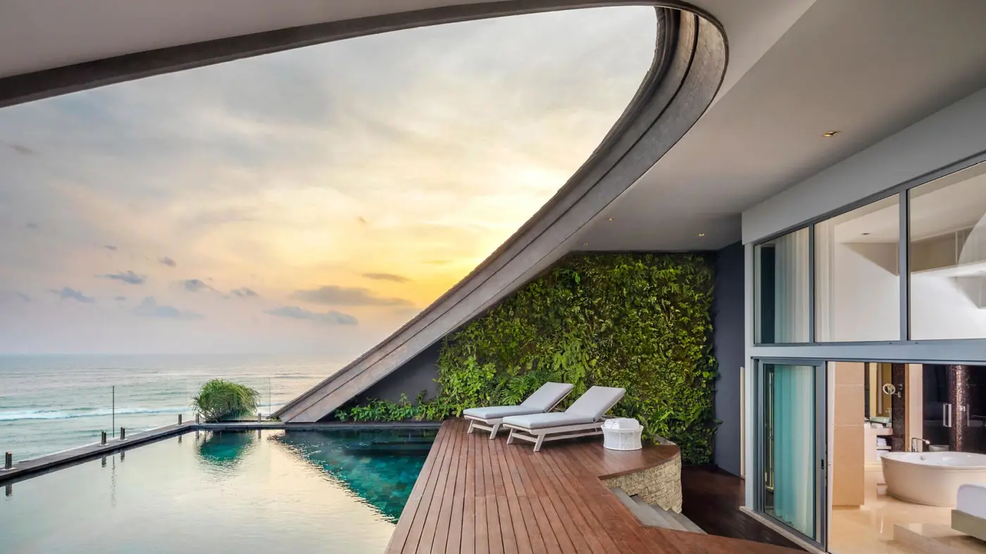 A penthouse pool at Como Uma Canggu at sunset