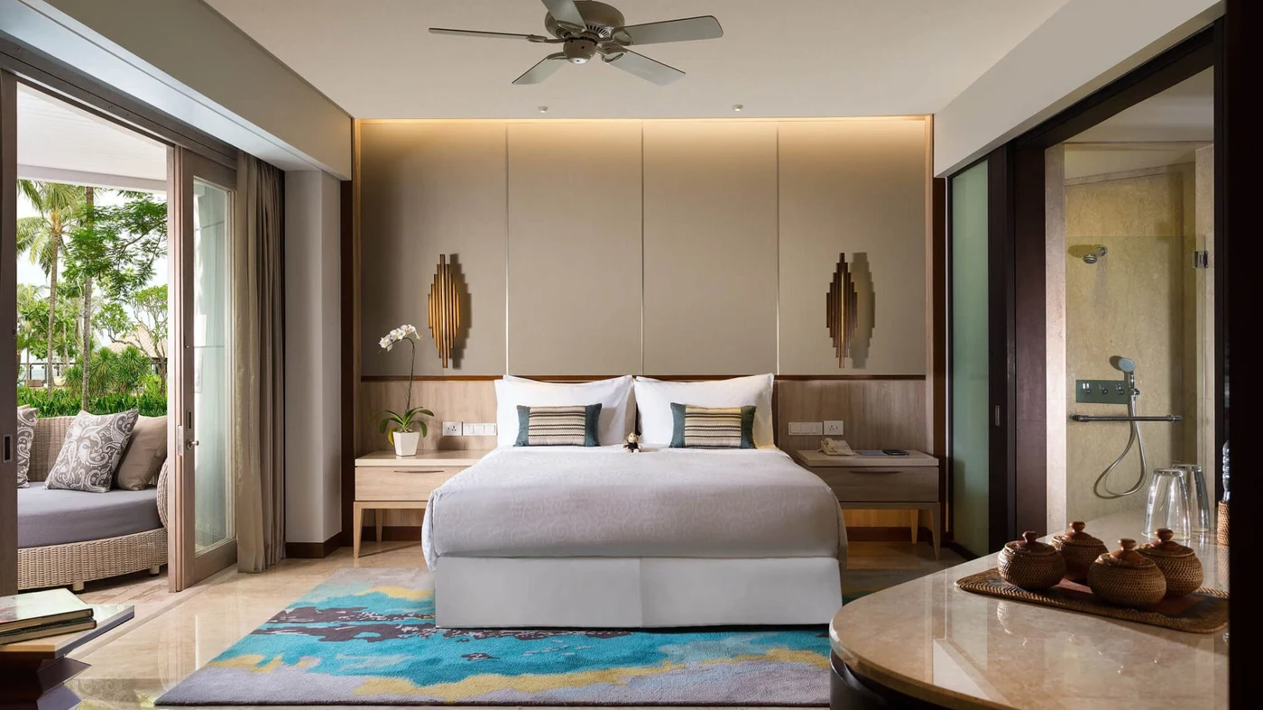 A renovated room at Conrad Bali, Komang the Conrad Monkey on the pillow