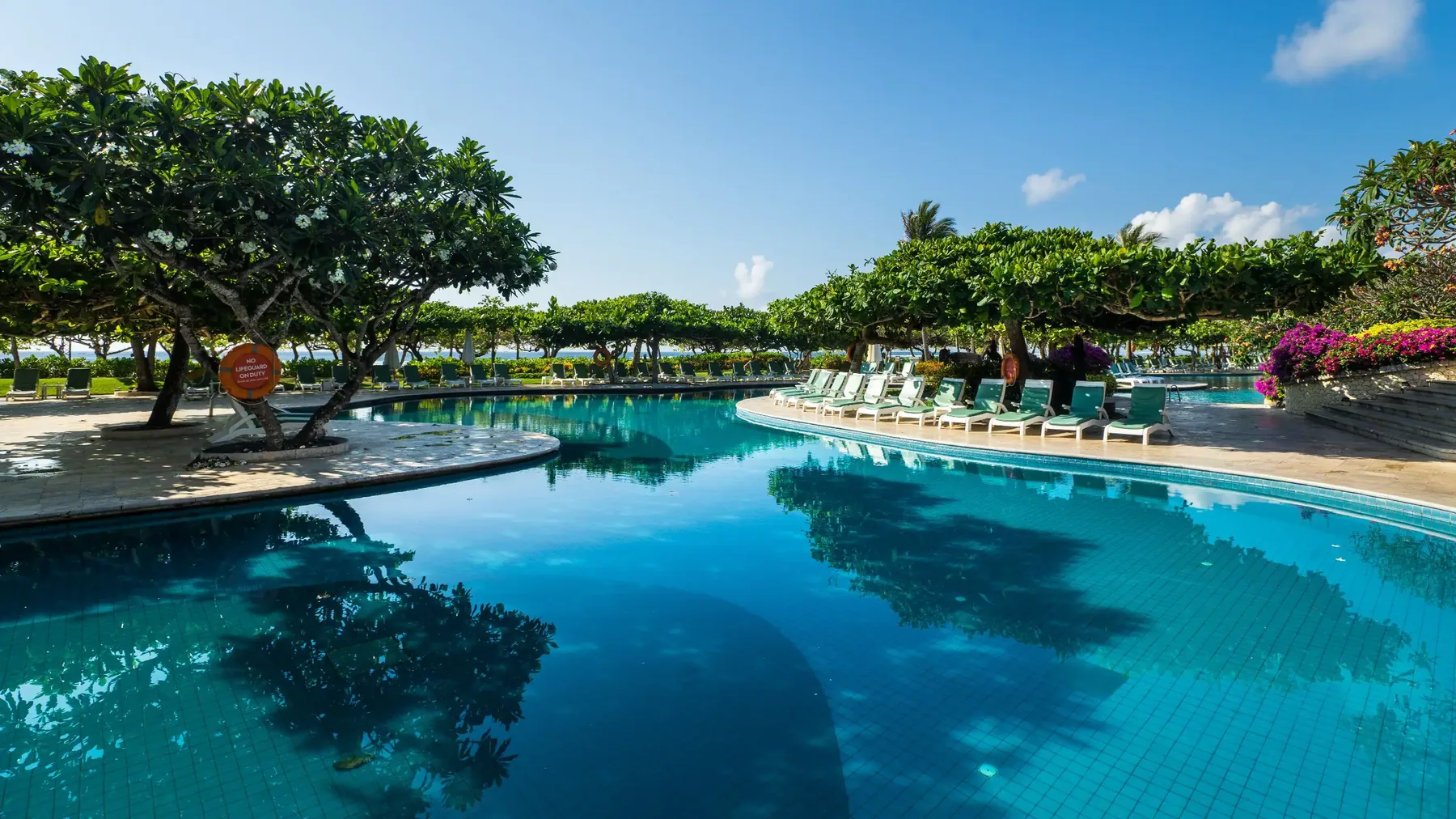 Rows of empty loungers along the lagoon pool at Grand Hyatt Bali