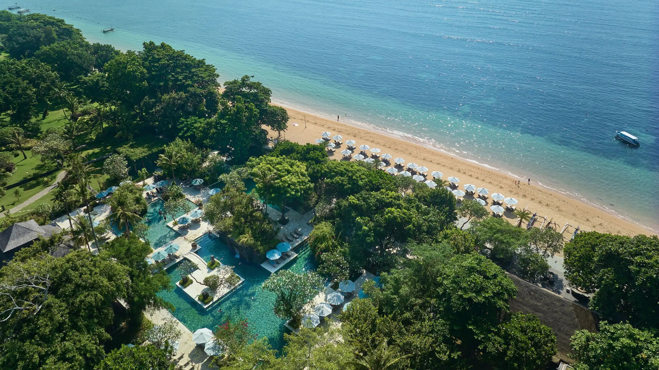 An aerial view of Hyatt Regency Bali in Sanur, showing the dense garden, pools, and 500 metres of beachfront