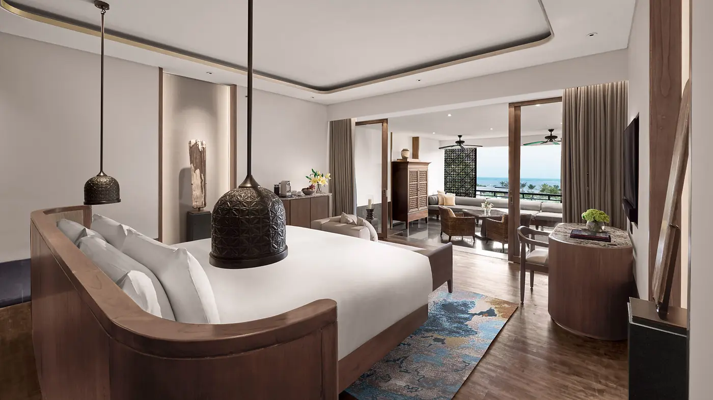 A Junior Suite bedroom at InterContinental Bali Sanur, opening onto a balcony with a sea view