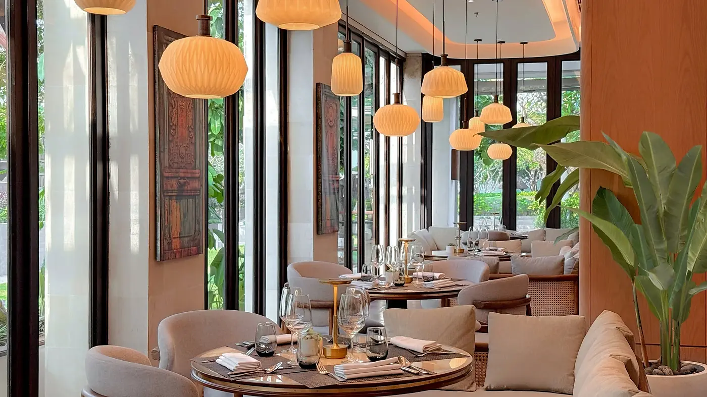 Layang Layang restaurant at InterContinental Bali Sanur, with paper lantern pendant lights over the dining tables