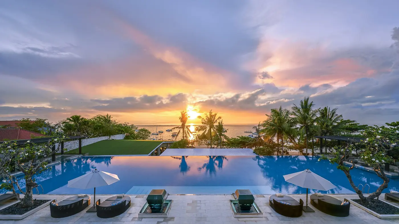 The main pool at InterContinental Bali Sanur at sunset, looking out towards the water