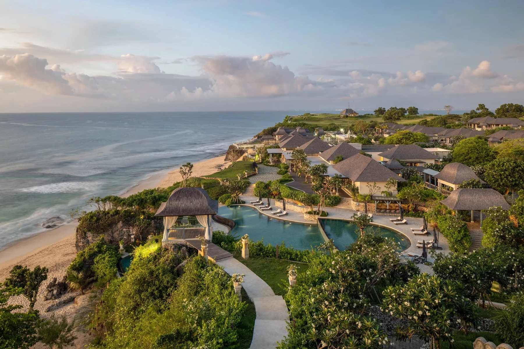 Jumeirah Bali's Majapahit water palace and pools above Dreamland Beach at dusk