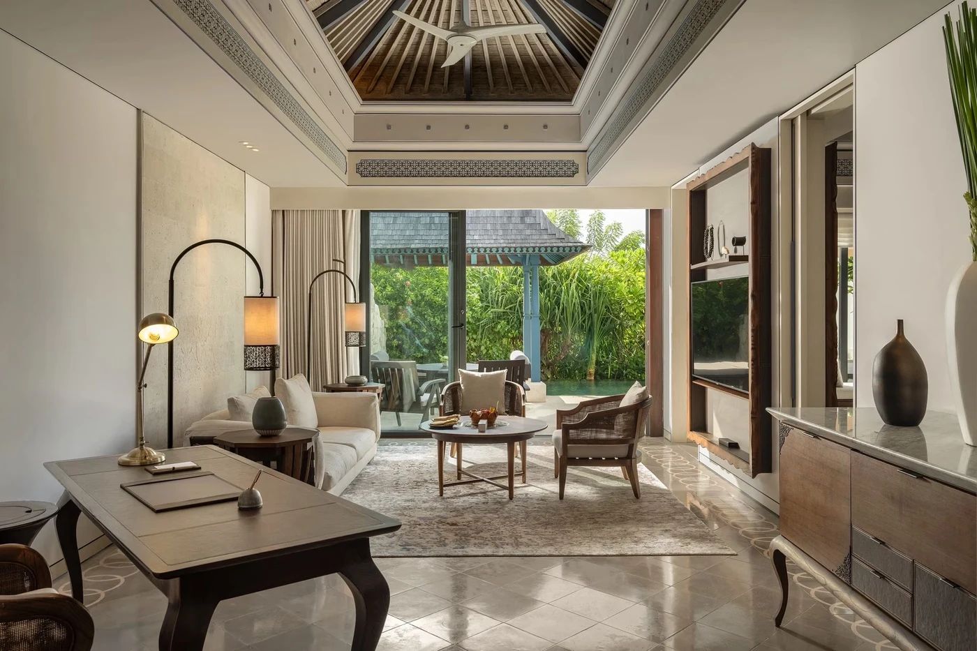 The living room of a villa at Jumeirah Bali, opening onto its private pool and garden pavilion