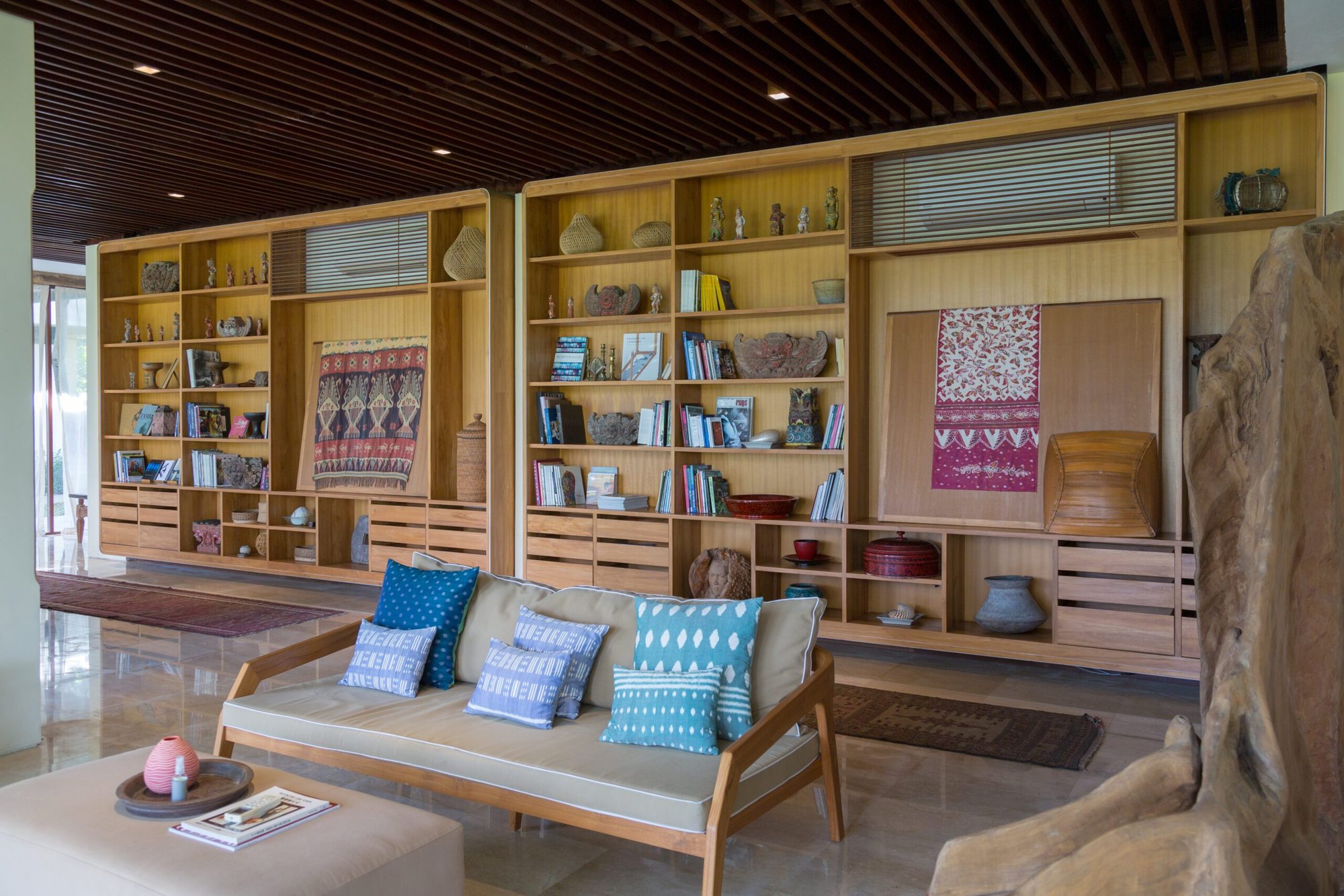 Lounge at Komaneka at Keramas Beach displaying the family's collection of Balinese art, textiles and antiques