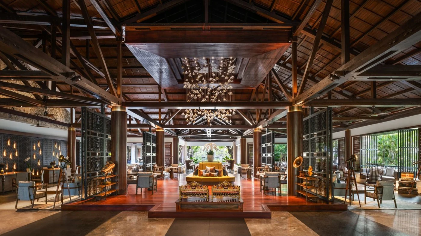 The lobby at The Laguna, with the carved Dewi Danu panel and traditional Balinese daybeds