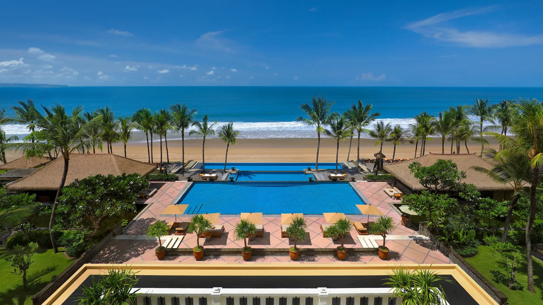 The Legian's pools stepping down past thatched pavilions to the beach and the Indian Ocean