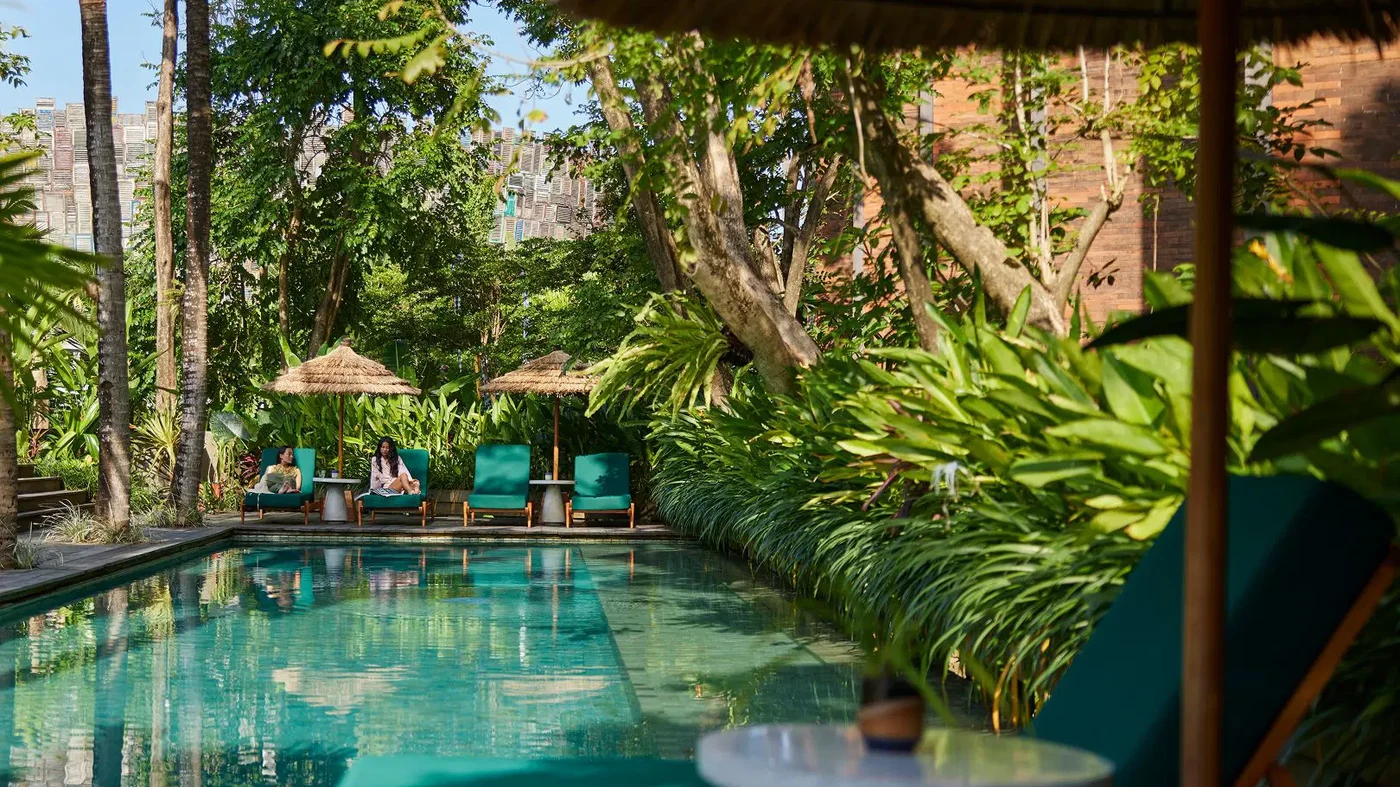 A quiet pool tucked into dense garden at Desa Potato Head