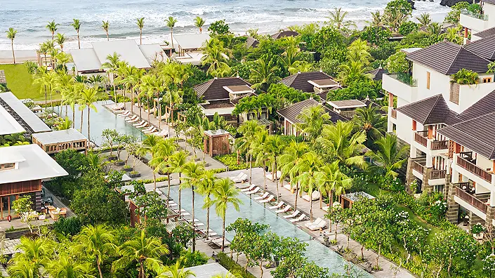 Aerial view of Regent Bali Canggu's pools and gardens running down to the beach at Batu Bolong