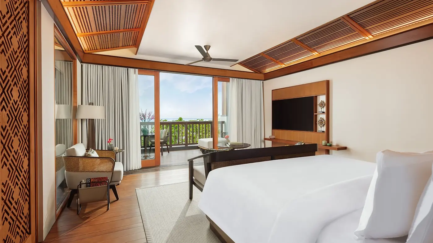 A Studio Suite bedroom at Regent Bali Canggu, opening onto a balcony with an ocean view