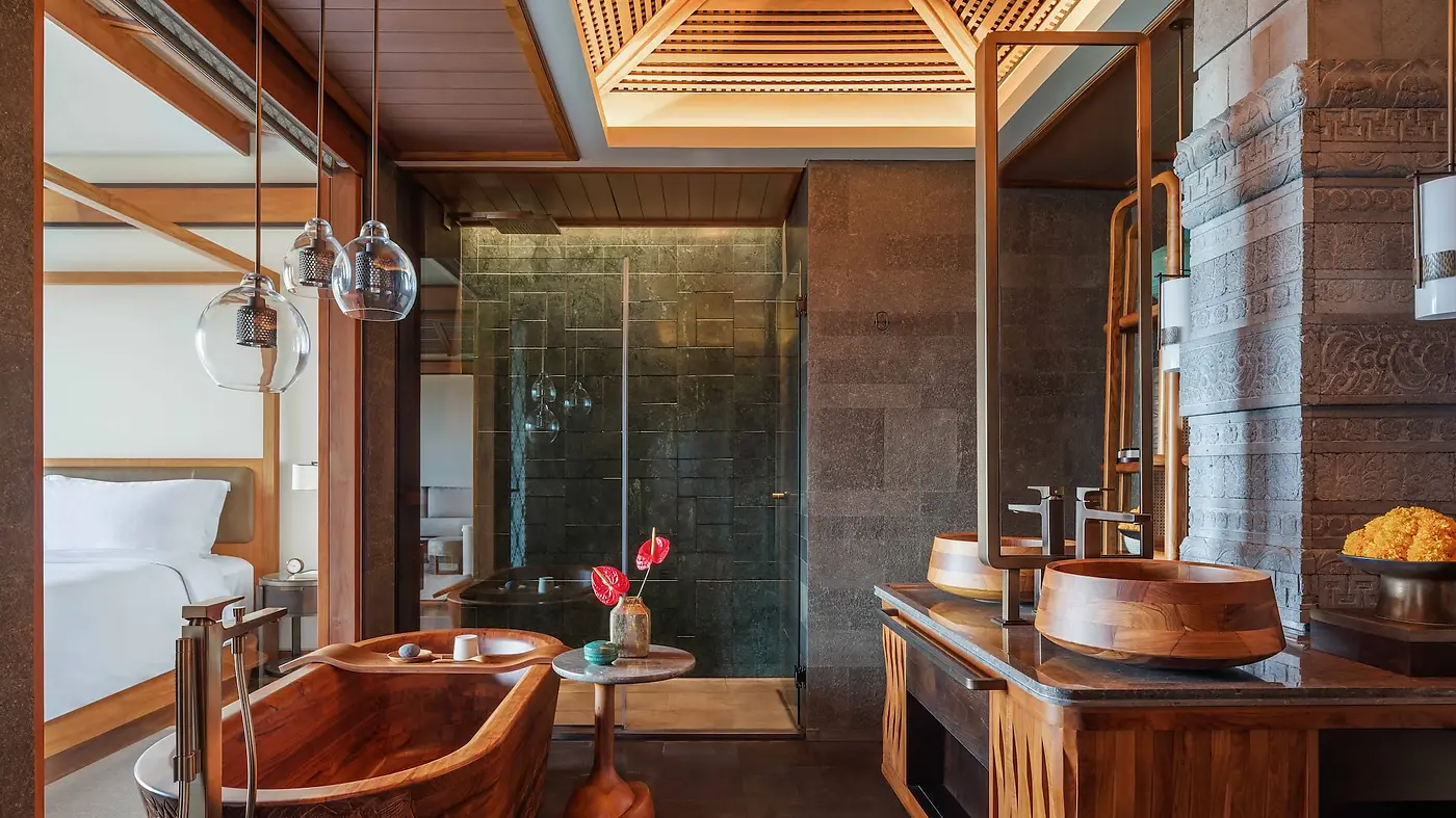 A hand-carved teak bathtub in a Studio Suite bathroom at Regent Bali Canggu