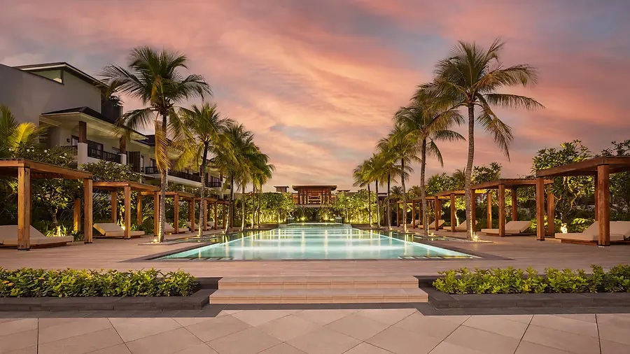 A pool at Regent Bali Canggu at sunset