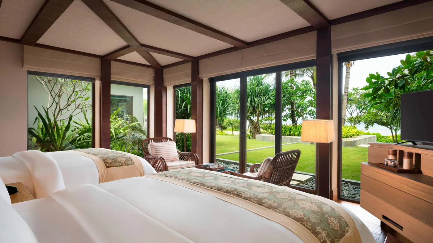 A villa bedroom at The Ritz-Carlton, Bali, opening onto its own garden