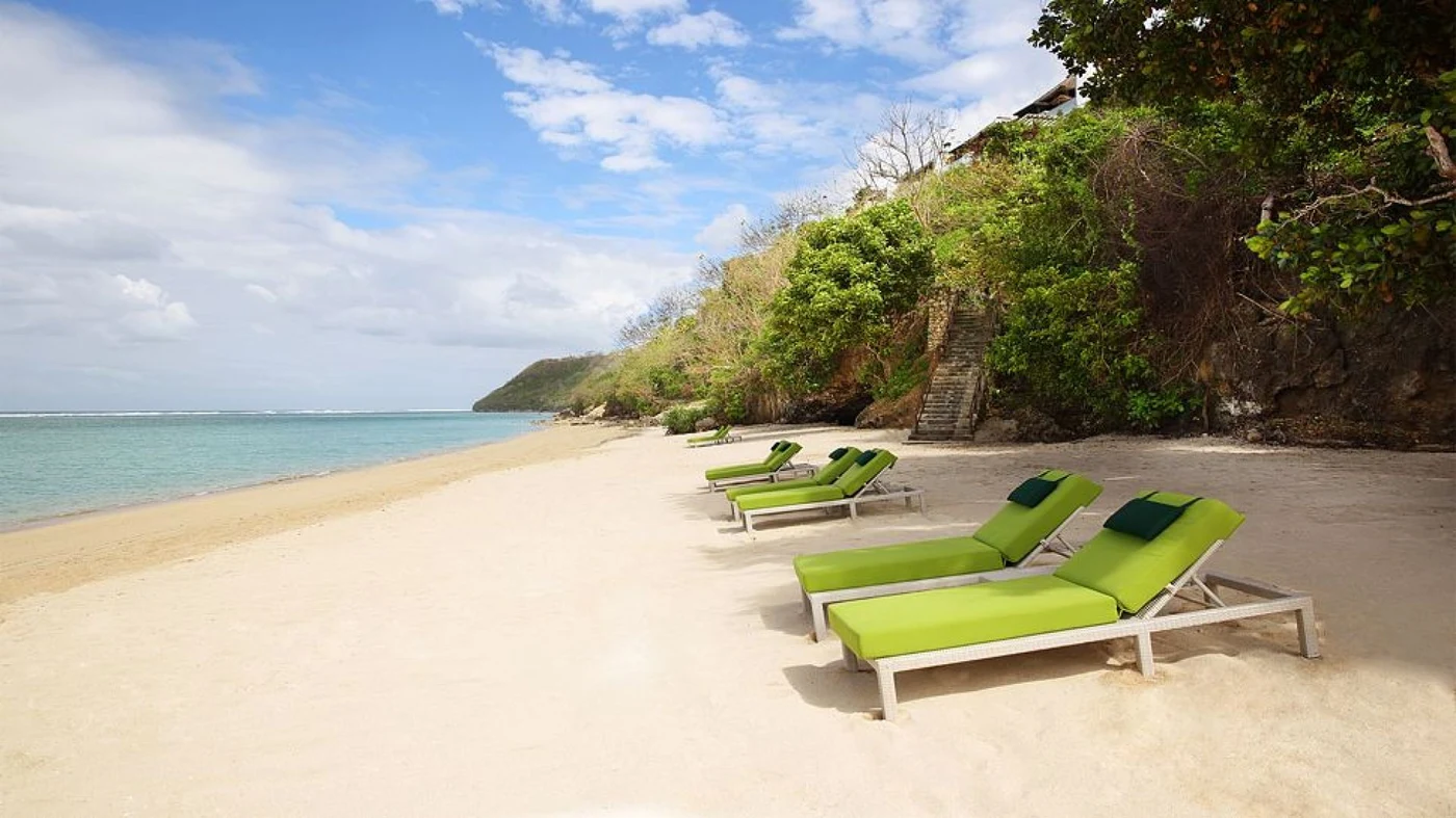 Samabe Bali's private beach at the base of the cliff, with the stairway down