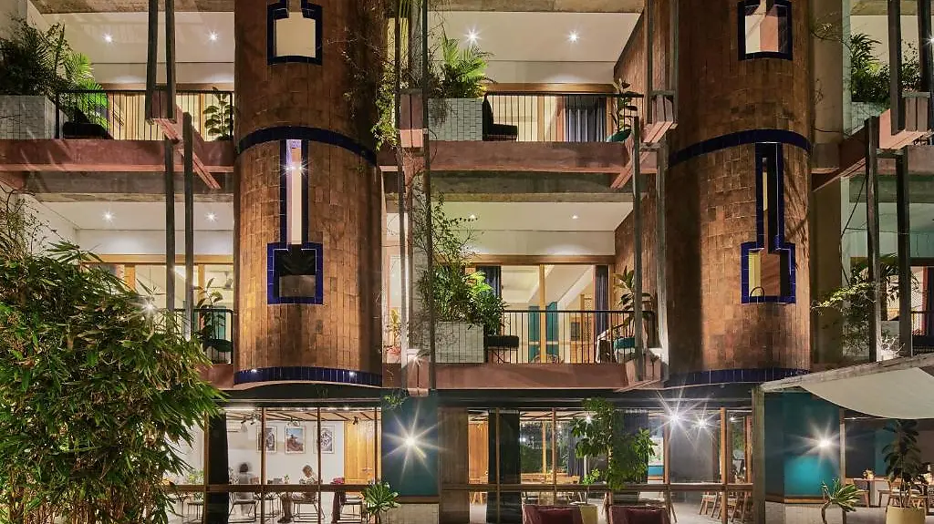 The terracotta-clad facade of Shore Amora lit up at night