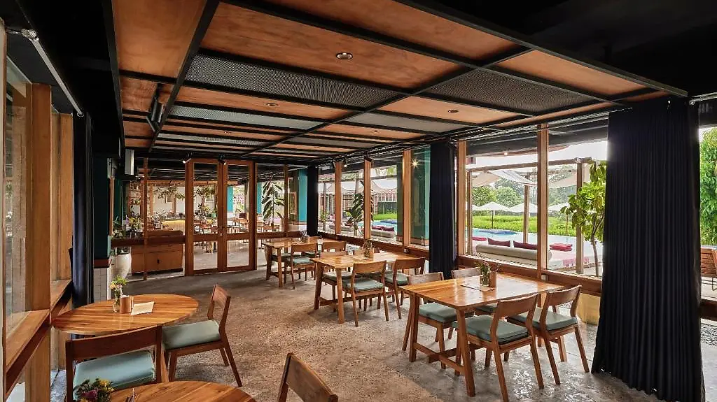 The restaurant at Shore Amora, wooden tables set for dinner