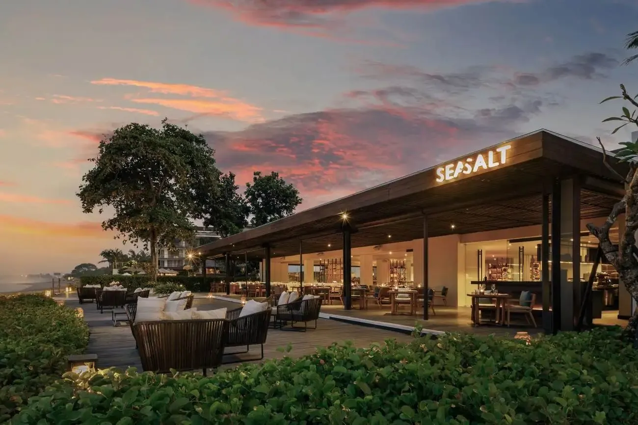Seasalt, the main restaurant at Alila Seminyak, lit up at dusk