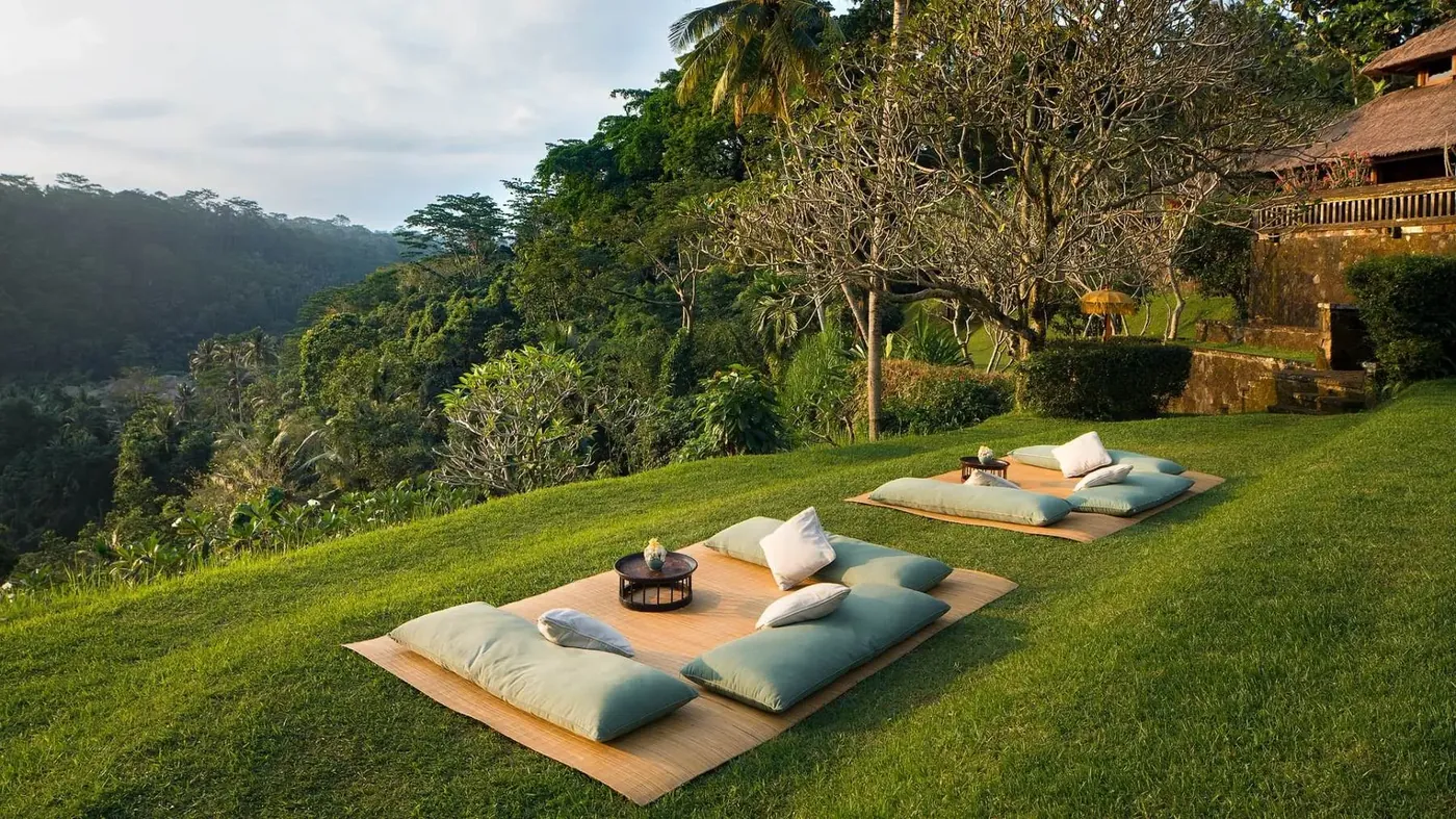 Cushions set out on the lawn overlooking the Ayung Valley at Amandari