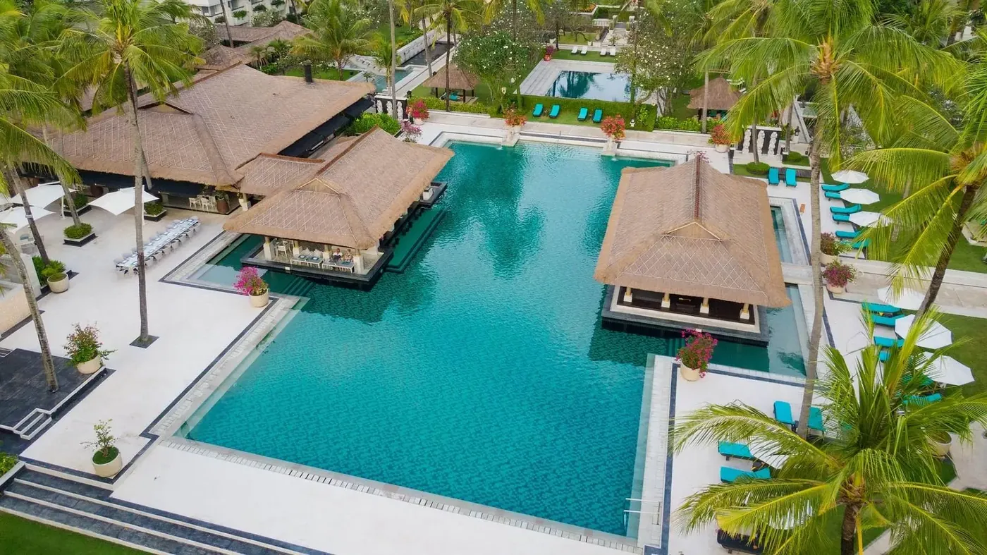 Aerial view of one of InterContinental Bali Resort's pools, with thatched pavilions