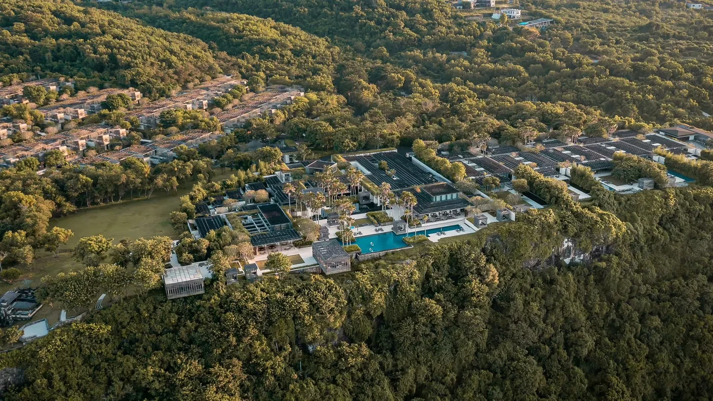 An aerial view of Alila Villas Uluwatu across the clifftop, showing the villas, gardens and infinity pool