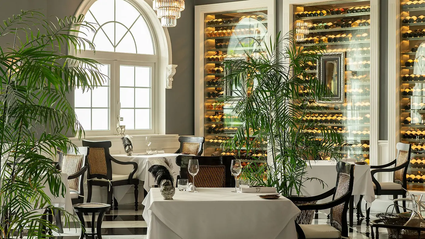 The dining room at Apéritif, Viceroy Bali's formal tasting-menu restaurant, with its glass-walled wine cellar