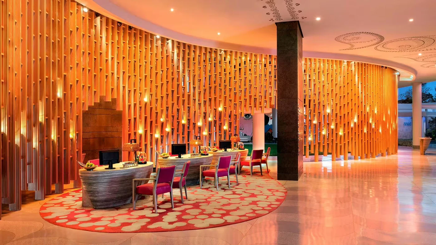 The lobby at W Bali, Seminyak, a curved wall of illuminated timber slats